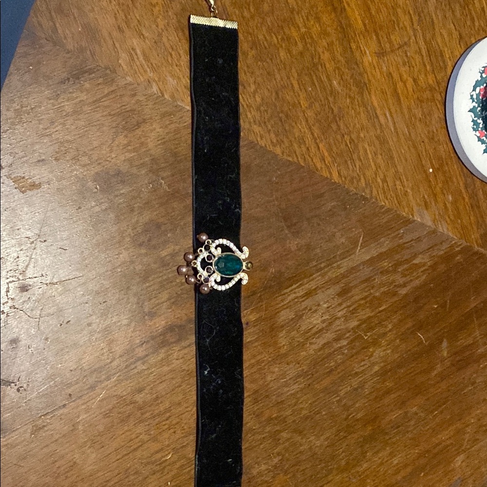 Elegant Black and Gold Bracelet with Green Gemstone